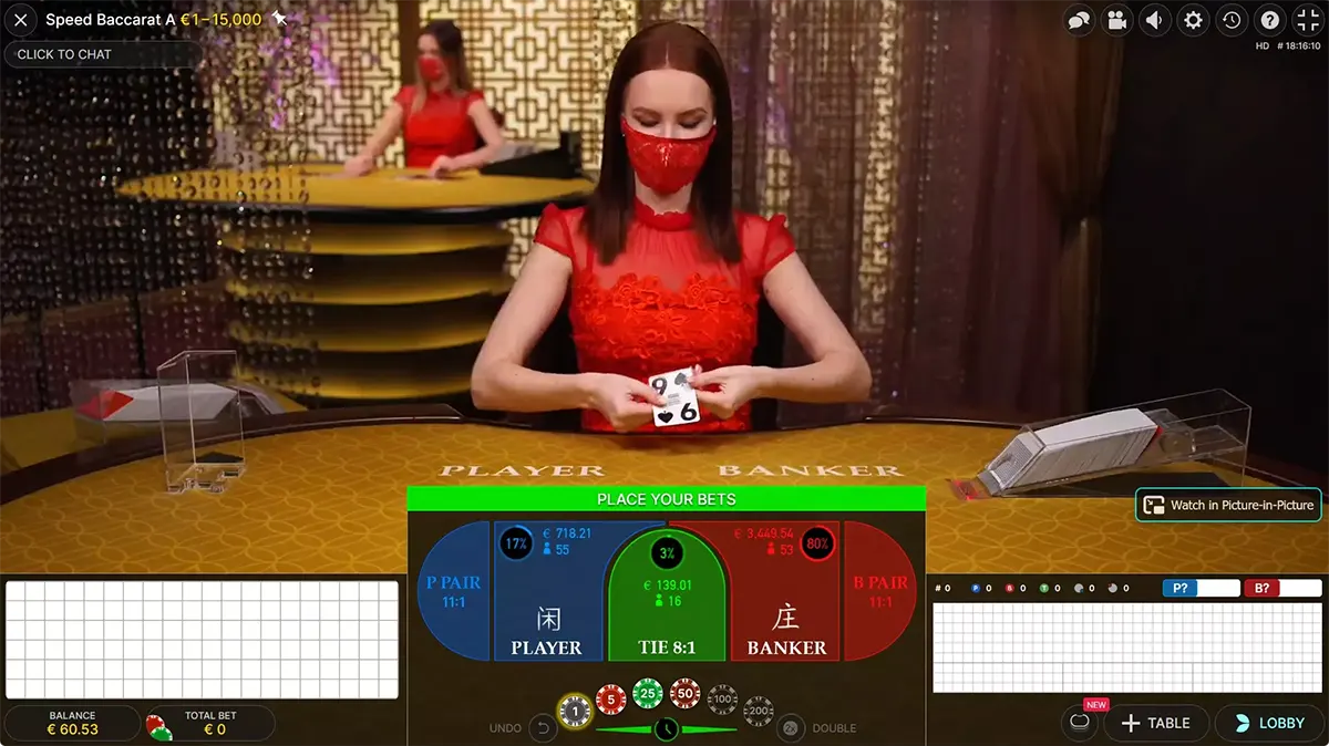 Live speed baccarat interface showing a dealer in a red dress and matching face mask dealing cards at a gold table, with Player/Banker betting panel, chip controls, and score grids displayed on screen.